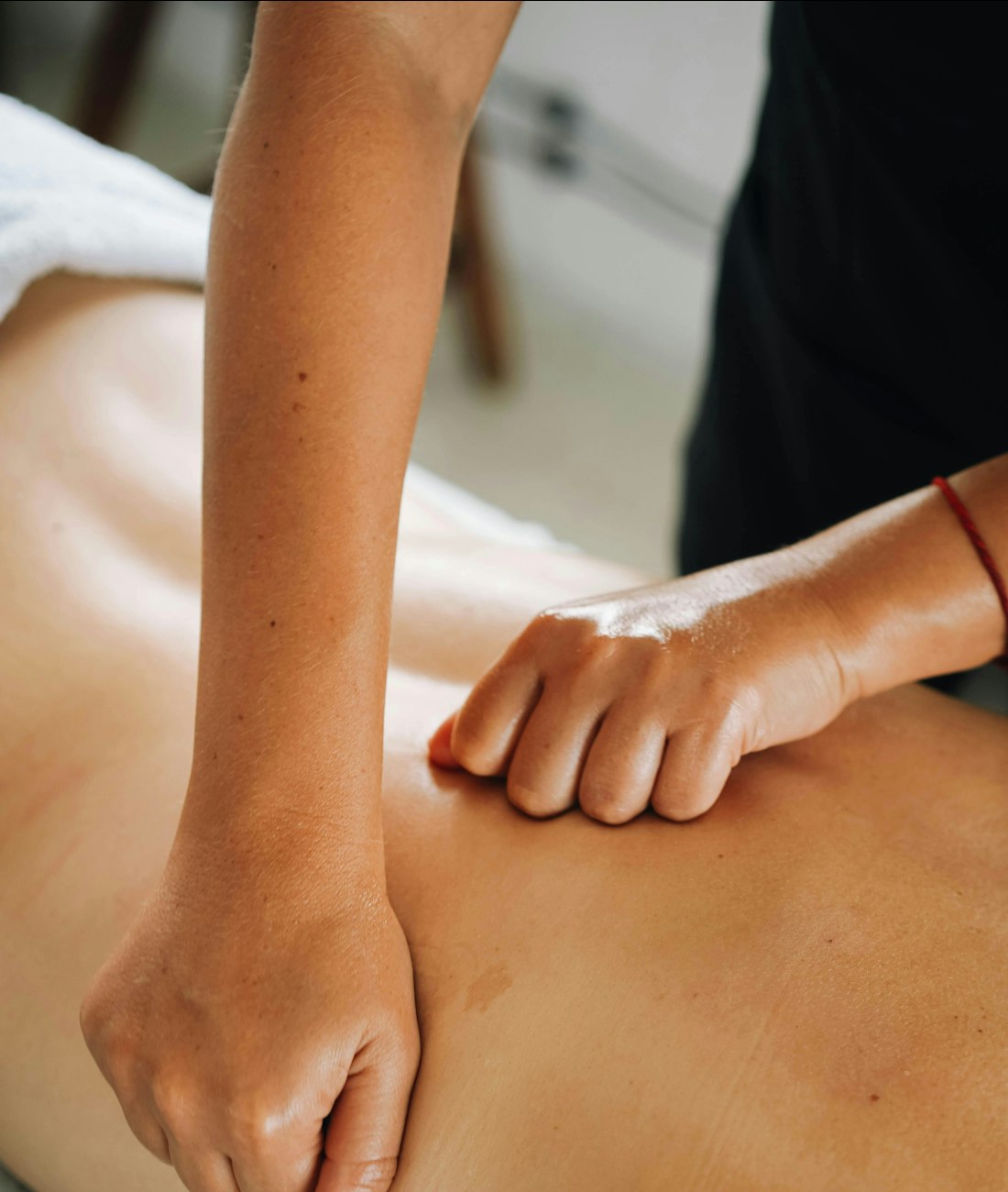 Therapist applying focused pressure to a client's upper back
